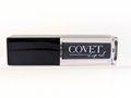 Covet Beauty’s Black Currant lip gloss — a deep black-violet gloss with shimmer in a clear rectangular tube with black cap. Transforms into a rich plum based on skin pH and heat.