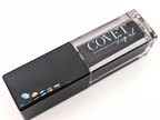 Covet Beauty’s Black Currant lip gloss — a deep black-violet gloss with shimmer in a clear rectangular tube with black cap. Transforms into a rich plum based on skin pH and heat.