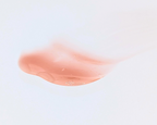 Swatch of Covet Beauty’s Latte Cream lip gloss — a soft light brown gloss with a creamy finish on a white background.