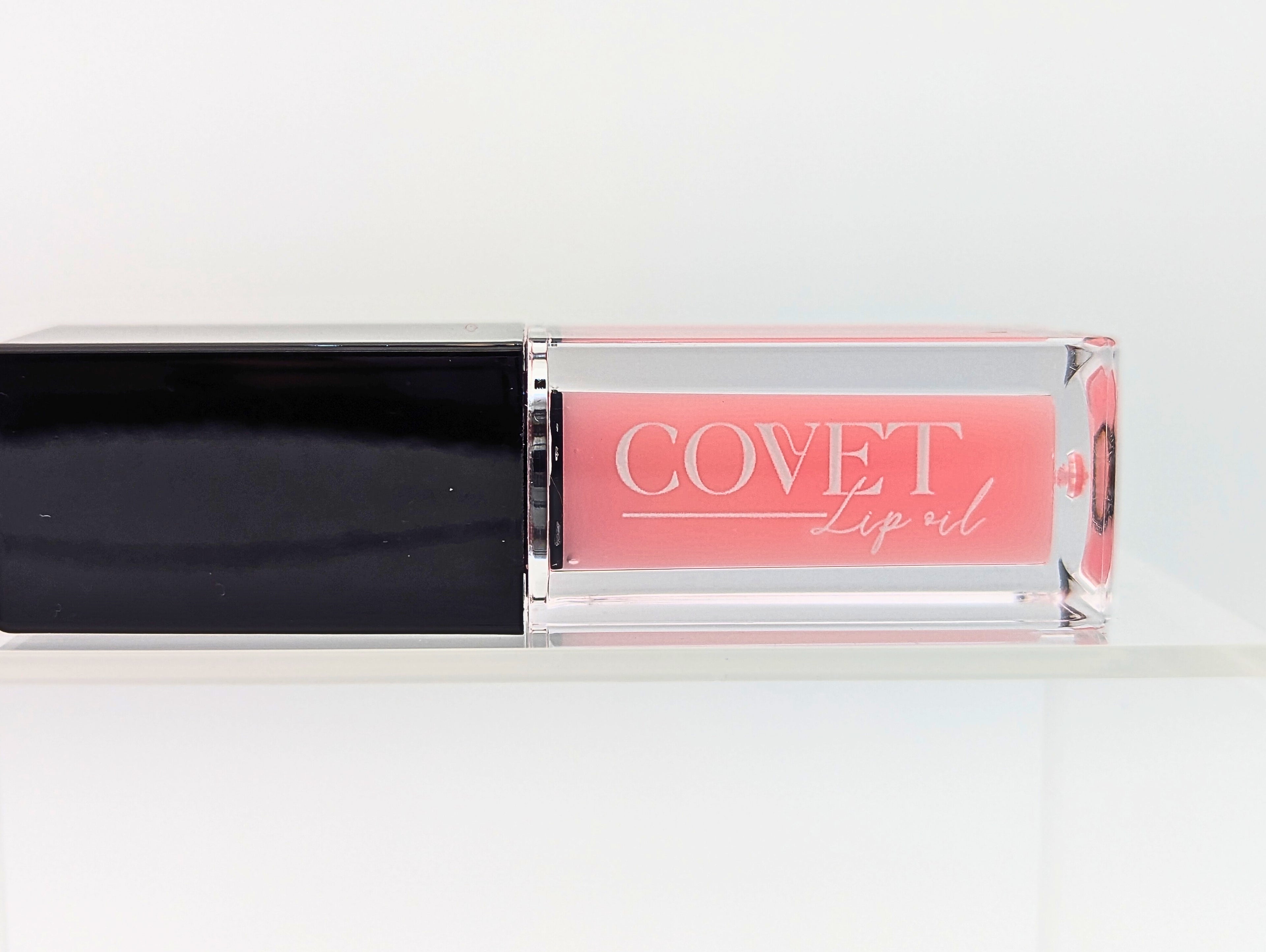 Covet Beauty’s Mercury lip gloss — a blush pink gloss in a clear rectangular tube with black cap. Transforms into a medium cool-toned pink based on skin pH and heat