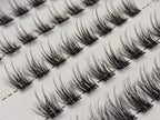 Covet Beauty Veil cluster lashes shown close-up in diagonal rows with soft, wispy fibers and a gentle curl.