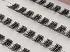 Covet Beauty Veil cluster lashes shown close-up in diagonal rows with soft, wispy fibers and a gentle curl.
