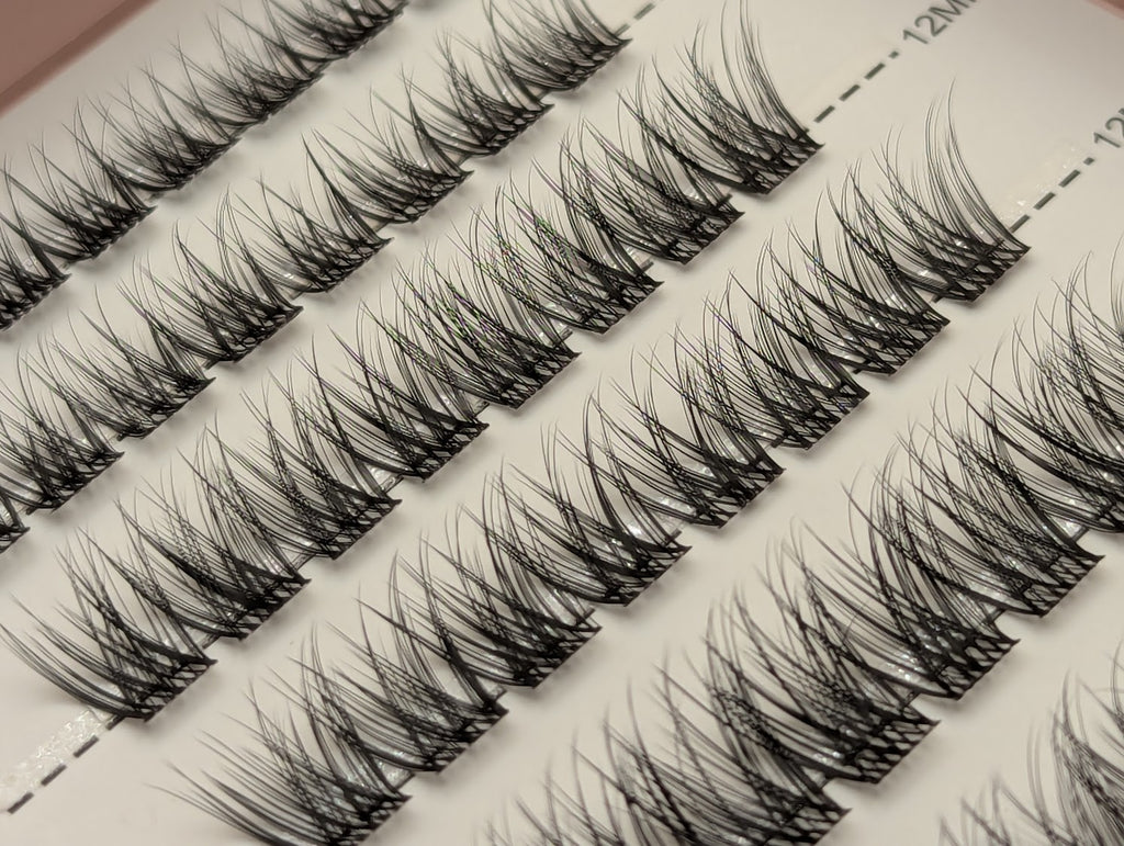 Covet Beauty Linger cluster lashes shown close-up in diagonal rows with soft curl and wispy lash fibers.