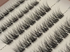 Covet Beauty Linger cluster lashes shown close-up in diagonal rows with soft curl and wispy lash fibers.