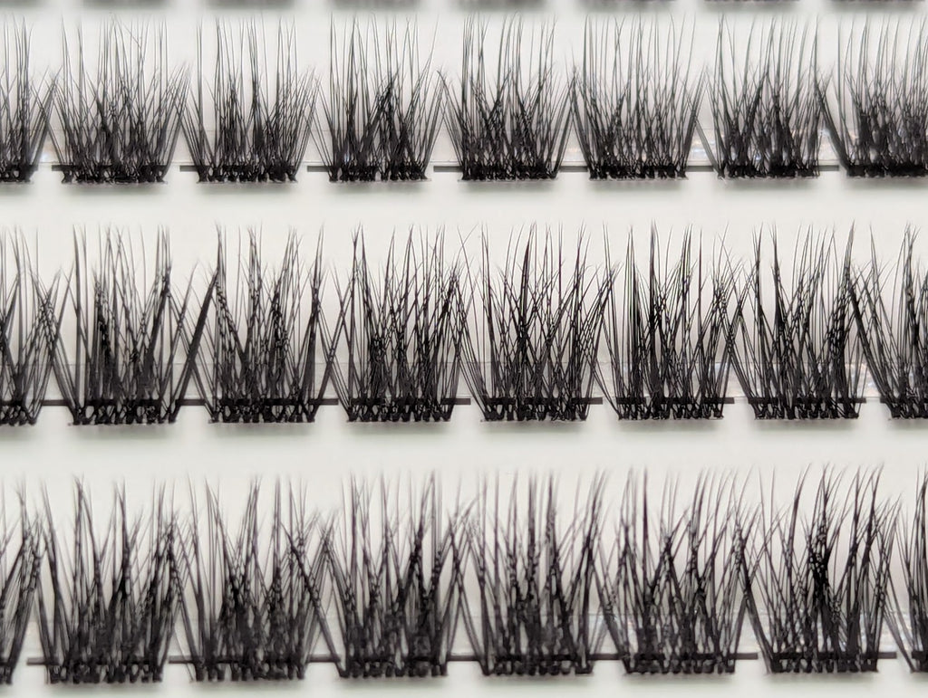 Close-up of Covet Beauty Trance cluster lashes showing airy, separated clusters arranged in rows.