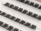 Covet Beauty Trance cluster lashes shown close-up in diagonal rows with soft curl and full, wispy lash fibers.