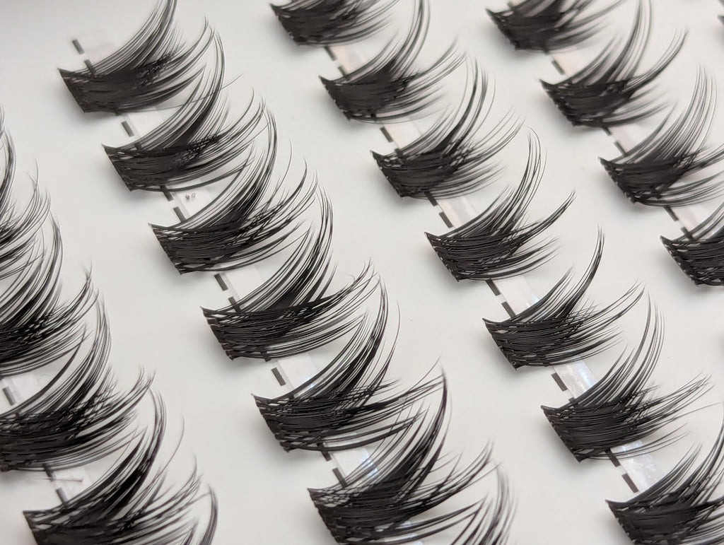 Covet Beauty Control cluster lashes shown close-up with separated, lifted lash clusters arranged in rows.