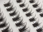 Covet Beauty Control cluster lashes shown close-up with separated, lifted lash clusters arranged in rows.