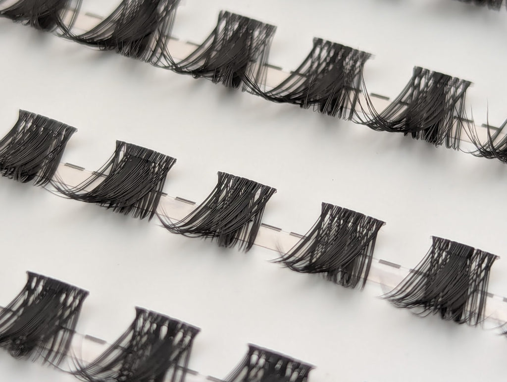 Covet Beauty Control cluster lashes shown close-up with lifted, curved lash clusters arranged in rows.