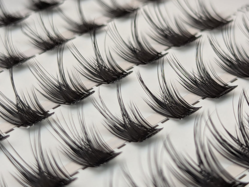 Close-up of Covet Beauty Control cluster lashes showing separated clusters with a lifted curl and defined lash shape.