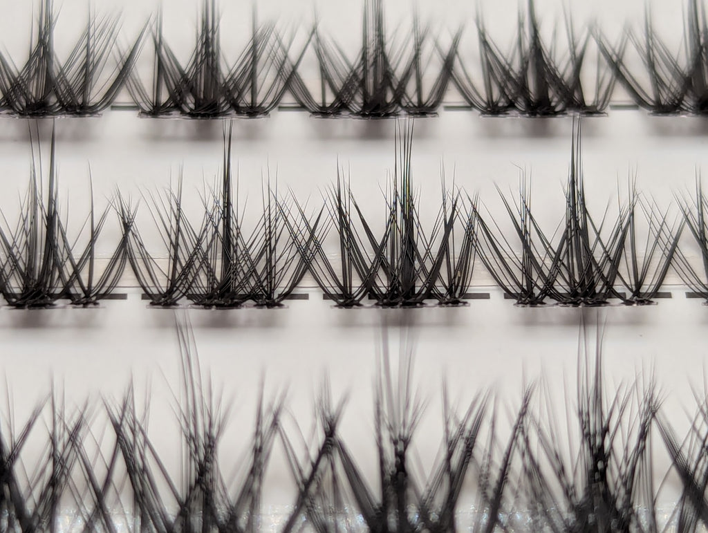 Covet Beauty Vision cluster lashes shown close-up with a soft, airy crisscross lash pattern in the tray.