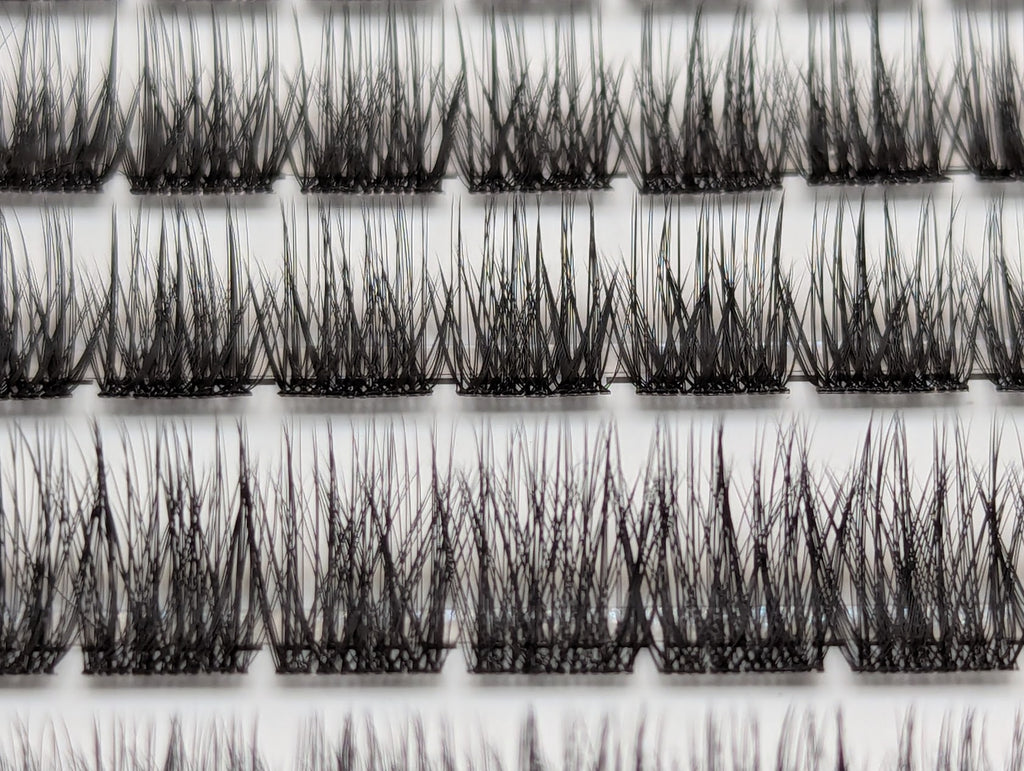 Covet Beauty Velvet cluster lashes shown close-up in the tray with rows of dense, defined crisscross lash fibers.