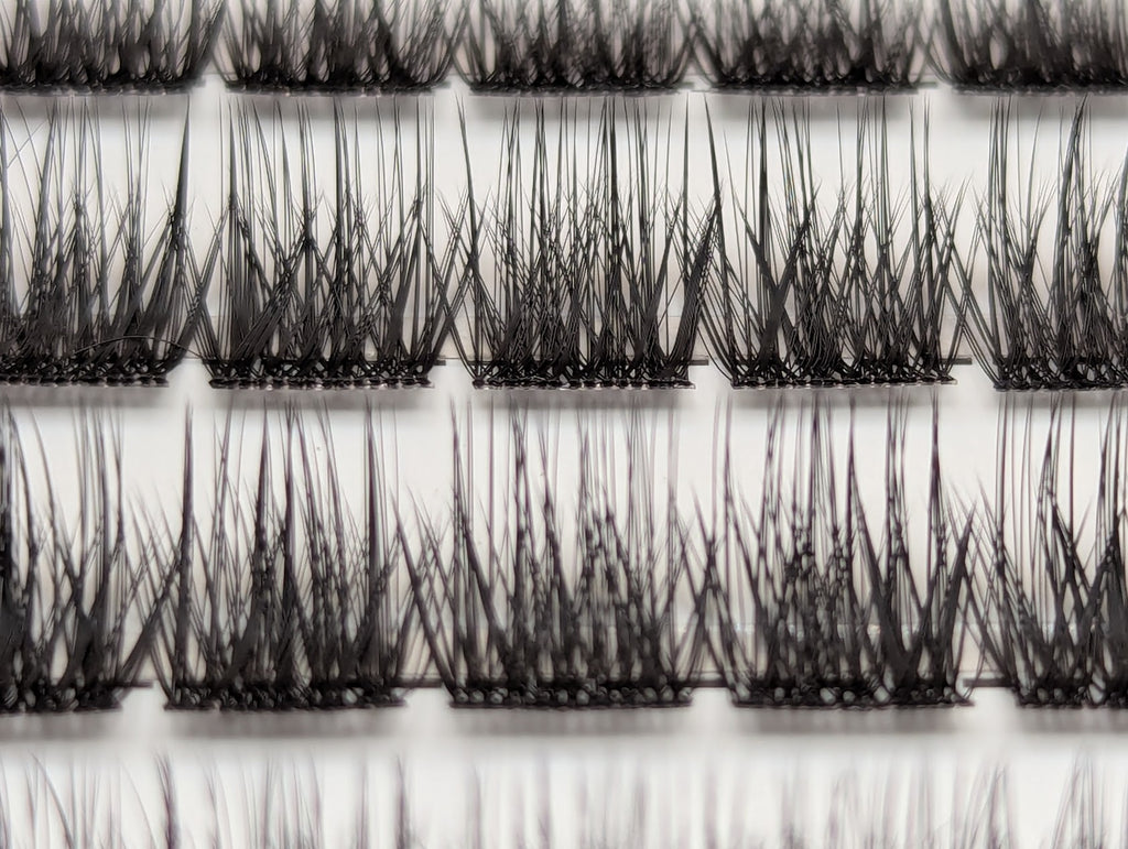 Covet Beauty Velvet cluster lashes shown close-up with a dense, defined crisscross lash pattern in the tray.