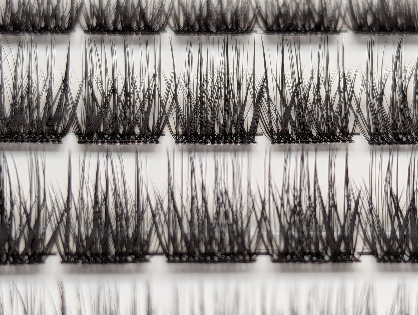Covet Beauty Velvet cluster lashes shown close-up with a dense, defined crisscross lash pattern in the tray.