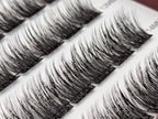 Covet Beauty Velvet cluster lashes shown close-up with dense, curled fibers and a defined lash pattern in the tray.