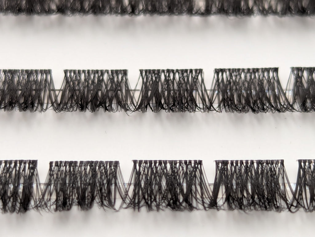 Close-up of Covet Beauty Velvet cluster lashes showing dense, compact lash segments and defined crisscross fibers in the tray.
