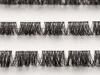 Close-up of Covet Beauty Velvet cluster lashes showing dense, compact lash segments and defined crisscross fibers in the tray.