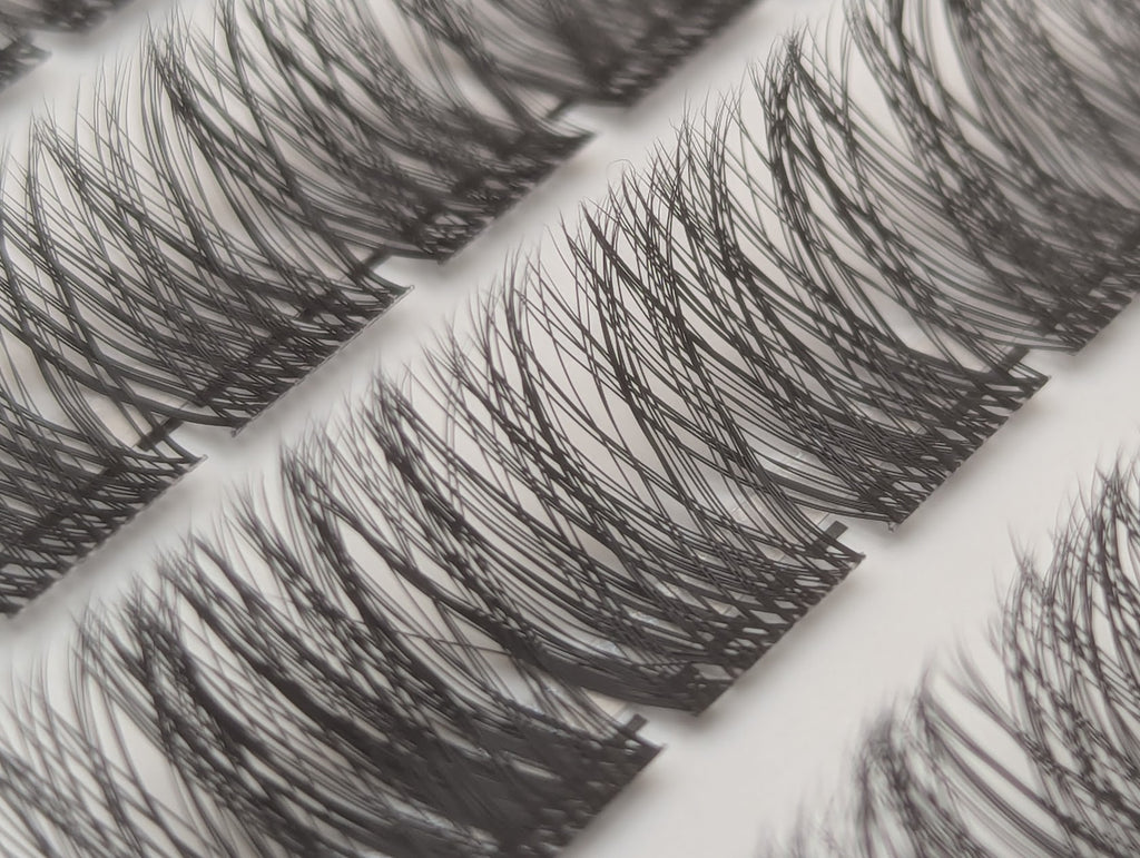 Close-up of Covet Beauty Hush cluster lashes showing a light, wispy lash pattern in the tray.