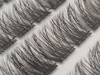 Close-up of Covet Beauty Hush cluster lashes showing a light, wispy lash pattern in the tray.