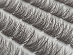 Covet Beauty Hush cluster lashes shown close-up with soft, wispy layered fibers in the tray.