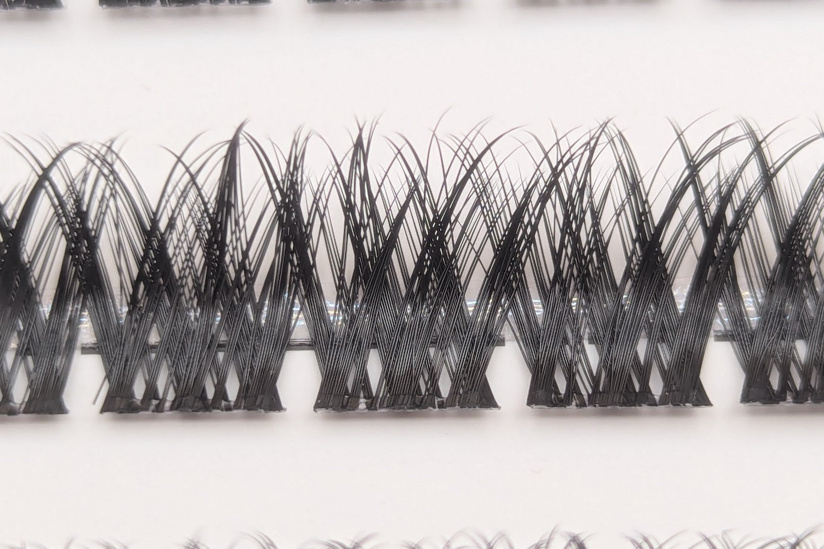 Covet Beauty Obsession cluster lashes shown close-up with a dense crisscross lash pattern.