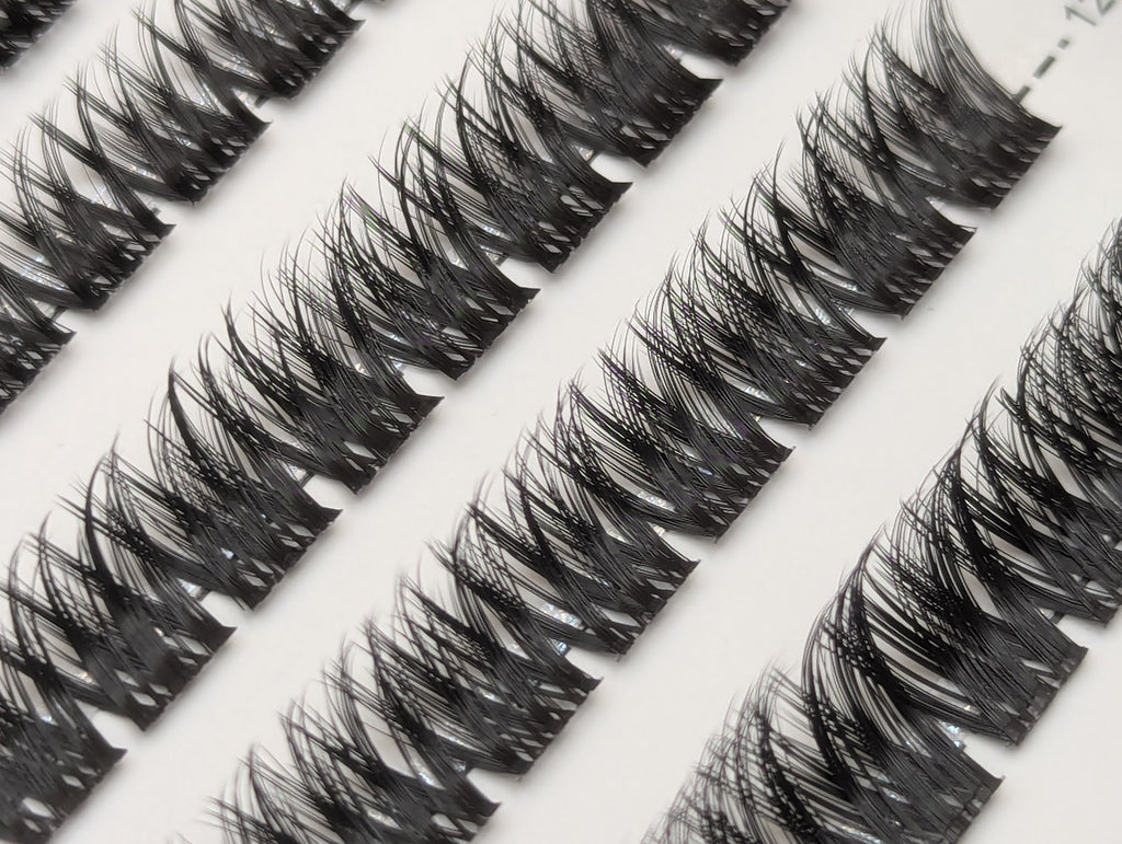Close-up of Covet Beauty Obsession cluster lashes showing a wispy crisscross pattern in the tray.