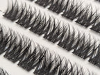 Close-up of Covet Beauty Obsession cluster lashes in the tray, showing rows of dense crisscross lash clusters.