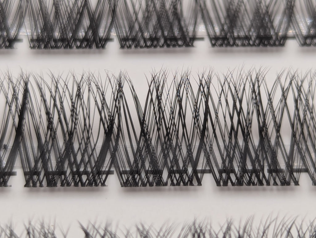 Close-up of Covet Beauty Hush cluster lashes showing a wispy crisscross lash pattern in the tray.