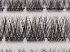 Close-up of Covet Beauty Hush cluster lashes showing a wispy crisscross lash pattern in the tray.