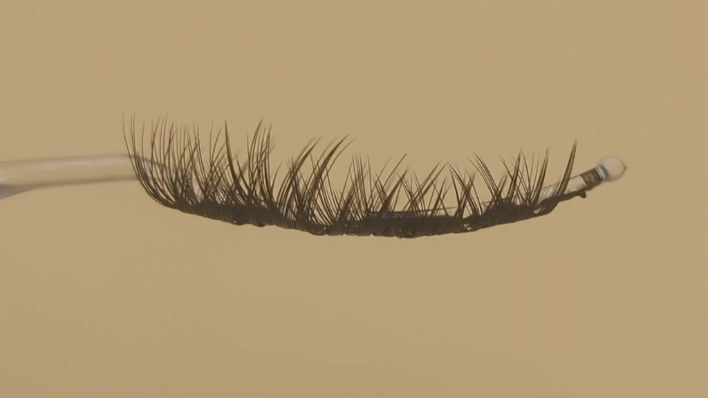 Covet Beauty Obsession cluster lashes shown on a display wand, moving up and down to highlight the curl, volume, and crisscross pattern.