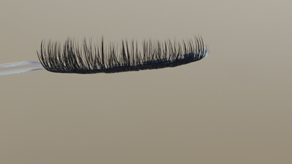 Covet Beauty Velvet cluster lashes on a display wand, moving up and down to show the curl, density, and wet-lash inspired finish.